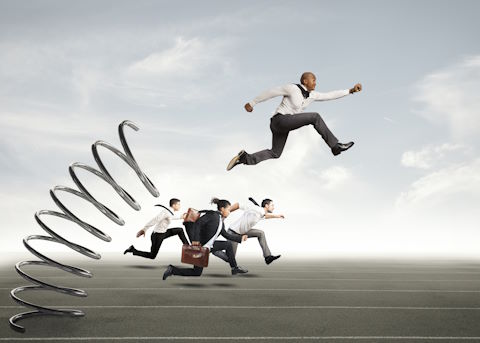Image showing a worker using a spring to leap ahead of other workers representing competitive advantage